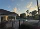 Community pool area features a pool house with chairs and tables surrounded by a secure fence at 2715 Bartlet Dr, Kissimmee, FL 34741