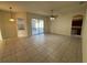 Spacious living room featuring tile floors, neutral paint, sliding glass doors to the outdoor space, and a ceiling fan at 2715 Bartlet Dr, Kissimmee, FL 34741