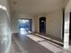 Open concept living area with tile flooring, light walls and sliding glass doors leading to the pool area at 2715 Bartlet Dr, Kissimmee, FL 34741