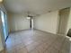 Spacious open-concept living area with a ceiling fan, tile flooring, and glass sliding doors to the backyard at 2715 Bartlet Dr, Kissimmee, FL 34741