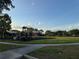 A spacious neighborhood playground area features play equipment and a sprawling green space at 2715 Bartlet Dr, Kissimmee, FL 34741