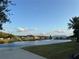 Scenic community pond view features waterfront homes, a fountain and lush green landscaping at 2715 Bartlet Dr, Kissimmee, FL 34741