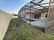 This screened pool area has a concrete patio and an adjacent grassy lawn at 2715 Bartlet Dr, Kissimmee, FL 34741