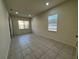 Versatile room with tile flooring, multiple windows providing ample natural light, and a neutral color palette at 2715 Bartlet Dr, Kissimmee, FL 34741