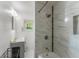 The bathroom features a shower and bath, with updated lighting, toilet, sink and a window at 290 Pine St, Ormond Beach, FL 32174