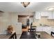 Bright dining area with wood flooring that gives way to the wood paneling of the living room at 290 Pine St, Ormond Beach, FL 32174