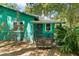 Inviting front entrance with covered porch and wicker chair, surrounded by lush foliage at 290 Pine St, Ormond Beach, FL 32174