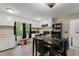 View of a well-lit kitchen featuring white cabinetry and a table with chairs for dining at 290 Pine St, Ormond Beach, FL 32174
