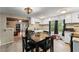 Functional kitchen and dining area featuring white cabinets and direct views to an open-plan living space at 290 Pine St, Ormond Beach, FL 32174
