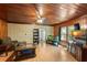 Inviting living room with wood-paneled ceiling, laminate floors and a cozy atmosphere at 290 Pine St, Ormond Beach, FL 32174