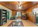 Warm living room features wood-paneled walls, an aquarium, and natural light at 290 Pine St, Ormond Beach, FL 32174