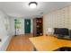 Bright home office with laminate floors, a brick accent wall, and natural light at 290 Pine St, Ormond Beach, FL 32174