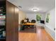 Home office with laminate floors, a brick accent wall, and a large window at 290 Pine St, Ormond Beach, FL 32174