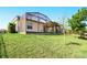 A private screened-in lanai overlooks a well-maintained backyard with lush green grass and mature trees at 3053 Brook Stone Ter, Davenport, FL 33837