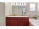 Bathroom featuring a double vanity, a soaking tub, and a separate shower at 3053 Brook Stone Ter, Davenport, FL 33837