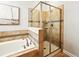 Bathroom featuring separate tub and shower with stylish tile surround and glass door at 3053 Brook Stone Ter, Davenport, FL 33837