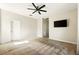 Bedroom featuring a ceiling fan, a television, and neutral-colored walls and carpet at 3053 Brook Stone Ter, Davenport, FL 33837