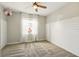 Bright bedroom with shiplap accent wall, neutral carpet, and a window with light-filtering curtains at 3053 Brook Stone Ter, Davenport, FL 33837
