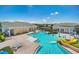 Resort-style community pool featuring a water slide, lounge areas, and tennis courts in the background at 3053 Brook Stone Ter, Davenport, FL 33837
