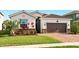 Charming single-Gathering home with a well-manicured lawn and a brick-paved driveway leading to an attached garage at 3053 Brook Stone Ter, Davenport, FL 33837