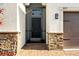A welcoming front entrance with a black door, brick columns, and a well-maintained walkway at 3053 Brook Stone Ter, Davenport, FL 33837