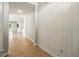 Hallway with wood-style floors and white wainscoting detail at 3053 Brook Stone Ter, Davenport, FL 33837