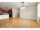 Well lit open concept space with the kitchen and living room, wood-look flooring throughout at 3053 Brook Stone Ter, Davenport, FL 33837