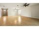 Spacious living room featuring wood-look tile floors, a modern light fixture, and ample natural light at 3053 Brook Stone Ter, Davenport, FL 33837