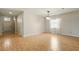 Bright living room with hardwood floors, a window, and a modern chandelier at 3053 Brook Stone Ter, Davenport, FL 33837
