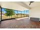 Enjoy outdoor living in this screened patio with brick pavers and view of the surrounding neighborhood at 3053 Brook Stone Ter, Davenport, FL 33837