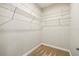 Empty carpeted walk-in closet with wire shelving racks for custom storage at 3053 Brook Stone Ter, Davenport, FL 33837