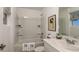 Bright bathroom with a tub and shower, well-lit vanity, and modern fixtures at 3133 Skyline Loop, Kissimmee, FL 34758