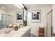 Bright bathroom featuring double sinks, a modern vanity, and a glass-enclosed shower at 3133 Skyline Loop, Kissimmee, FL 34758