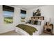 Cozy bedroom featuring plush bedding, neutral tones, and two bright windows with peaceful view at 3133 Skyline Loop, Kissimmee, FL 34758