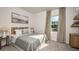 Comfortable bedroom features a decorative patterned curtain and a relaxing seaside painting at 3133 Skyline Loop, Kissimmee, FL 34758