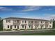 Attractive two-story townhomes with neutral colors and well-manicured lawns, located on a paved street at 3133 Skyline Loop, Kissimmee, FL 34758