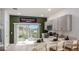 Modern kitchen featuring stainless steel appliances, sleek countertops, and a large sliding glass door at 3133 Skyline Loop, Kissimmee, FL 34758