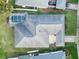 Aerial view of property with screened in pool, fenced yard and gray roof at 4087 Clock Tower Dr, Port Orange, FL 32129