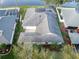 Aerial view showcasing the gray roof and lush backyard at 4087 Clock Tower Dr, Port Orange, FL 32129