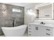 Beautiful bathroom featuring a soaking tub, illuminated mirror, and contemporary vanity with black hardware at 4087 Clock Tower Dr, Port Orange, FL 32129