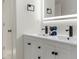 Modern bathroom features double sink vanity, LED mirror, and black fixtures against white walls at 4087 Clock Tower Dr, Port Orange, FL 32129
