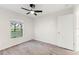 Peaceful bedroom with wood-look flooring, a ceiling fan, and a window with neighborhood views at 4087 Clock Tower Dr, Port Orange, FL 32129