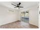 Bedroom with wood-look flooring, ceiling fan, and sliding glass doors to the backyard pool at 4087 Clock Tower Dr, Port Orange, FL 32129