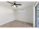 Bedroom with modern flooring, ceiling fan, and a window overlooking an outdoor space at 4087 Clock Tower Dr, Port Orange, FL 32129