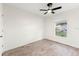 Relaxing bedroom with wood-look flooring, a ceiling fan, and a window with neighborhood views at 4087 Clock Tower Dr, Port Orange, FL 32129