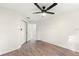 Comfortable bedroom with wood-look flooring, a ceiling fan, closet, and an open doorway at 4087 Clock Tower Dr, Port Orange, FL 32129
