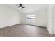 Bedroom features wood flooring, a ceiling fan, and a large window at 4087 Clock Tower Dr, Port Orange, FL 32129