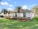 Side view of a well maintained home, showing the lawn, driveway, and easy access to the garage at 4087 Clock Tower Dr, Port Orange, FL 32129