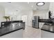 Bright kitchen features stainless steel appliances, dark countertops, and white cabinets at 4087 Clock Tower Dr, Port Orange, FL 32129