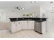 Kitchen showcases stainless steel dishwasher and dark countertop with white cabinets at 4087 Clock Tower Dr, Port Orange, FL 32129